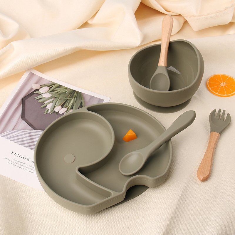 Coordinated silicone baby feeding products on a family table