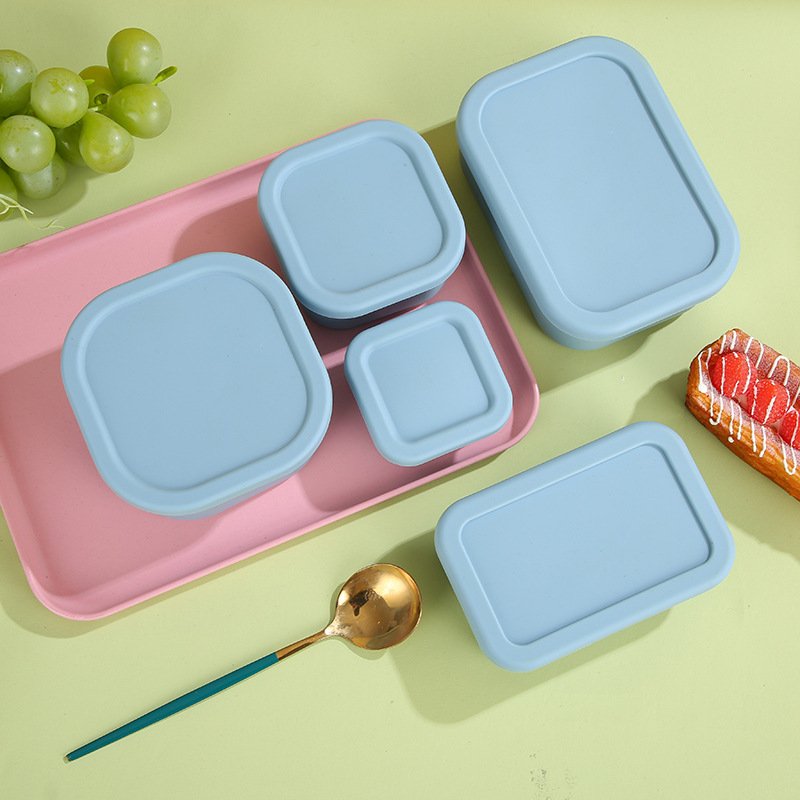 Silicone food storage containers arranged for packed meals